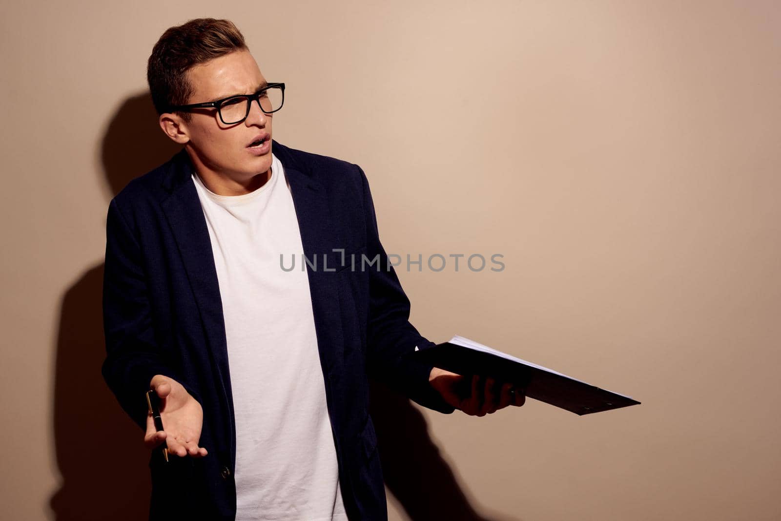 businessmen fashion posing with glasses beige background. High quality photo