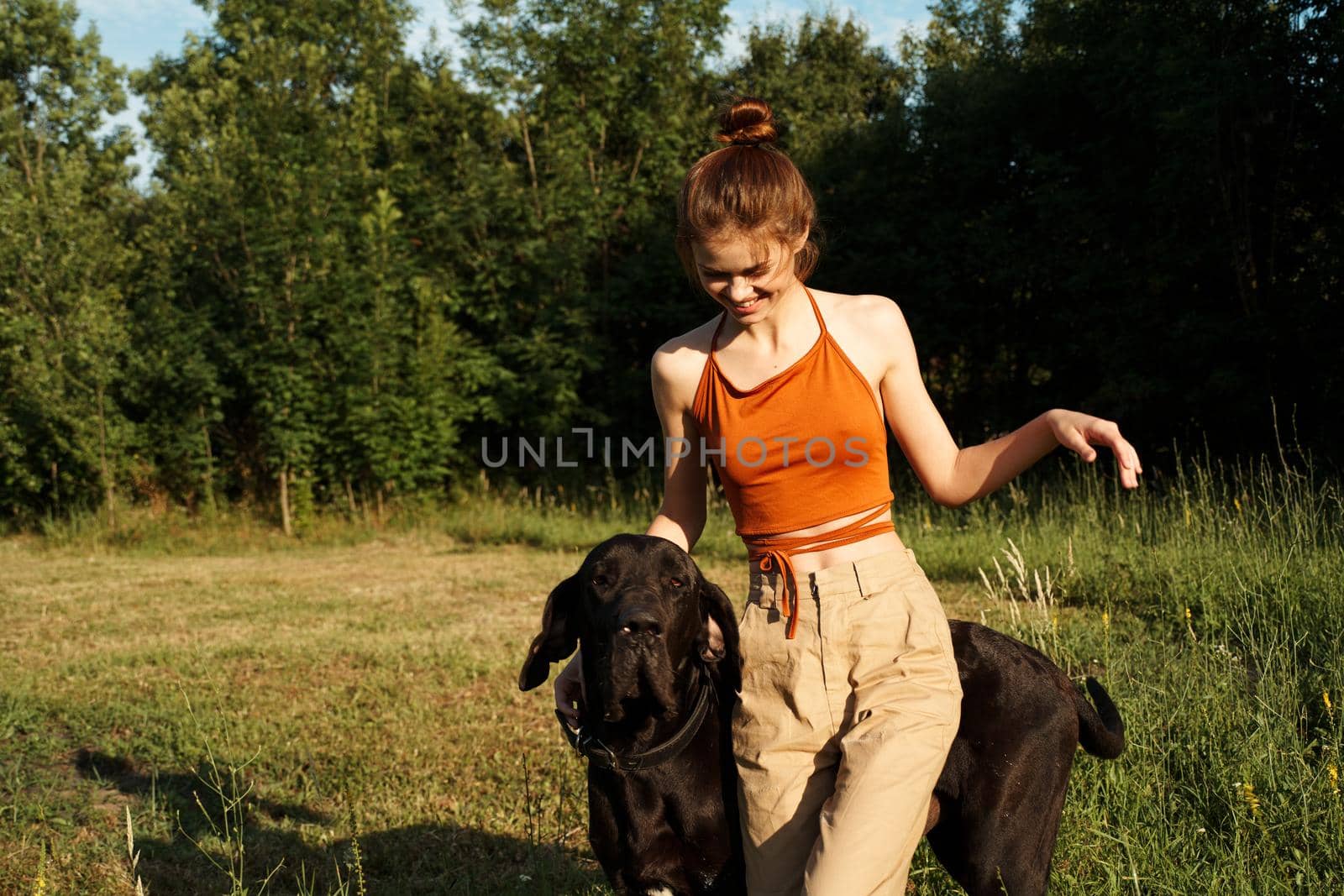 cheerful woman outdoors with dog and fun nature. High quality photo