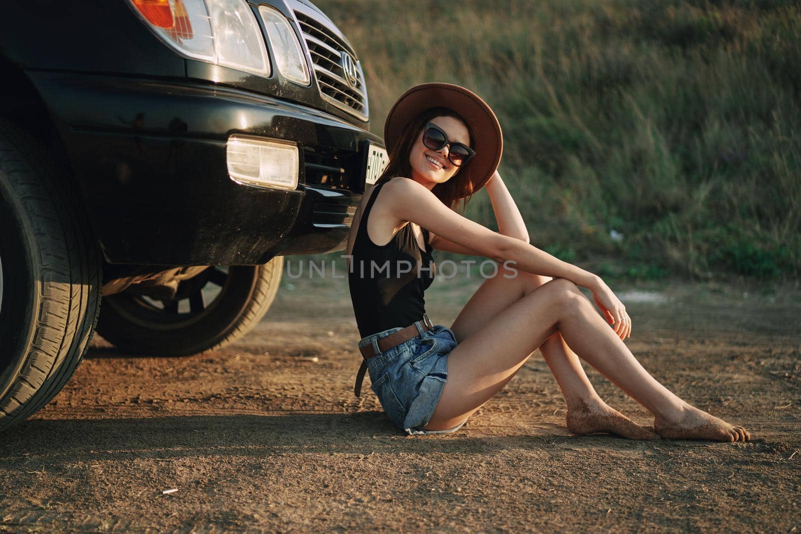 woman in sunglasses near car travel summer vacation landscape. High quality photo