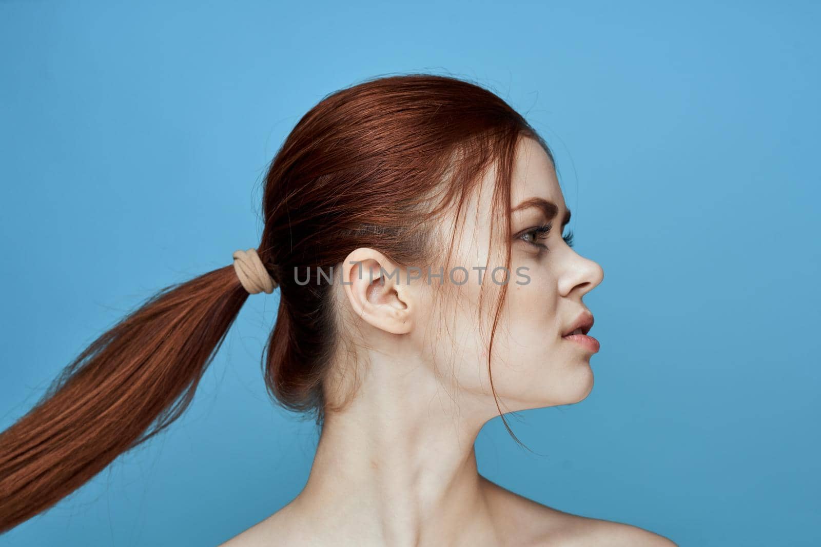 woman with bared shoulders pigtail emotions posing blue background by Vichizh