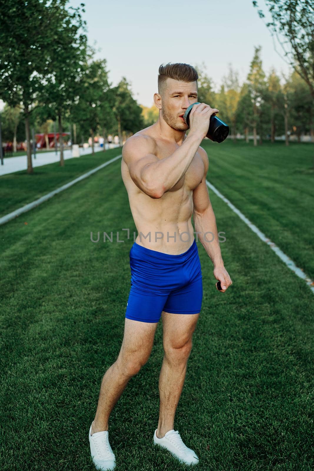 athletic man working out in the park crossfit exercise by Vichizh