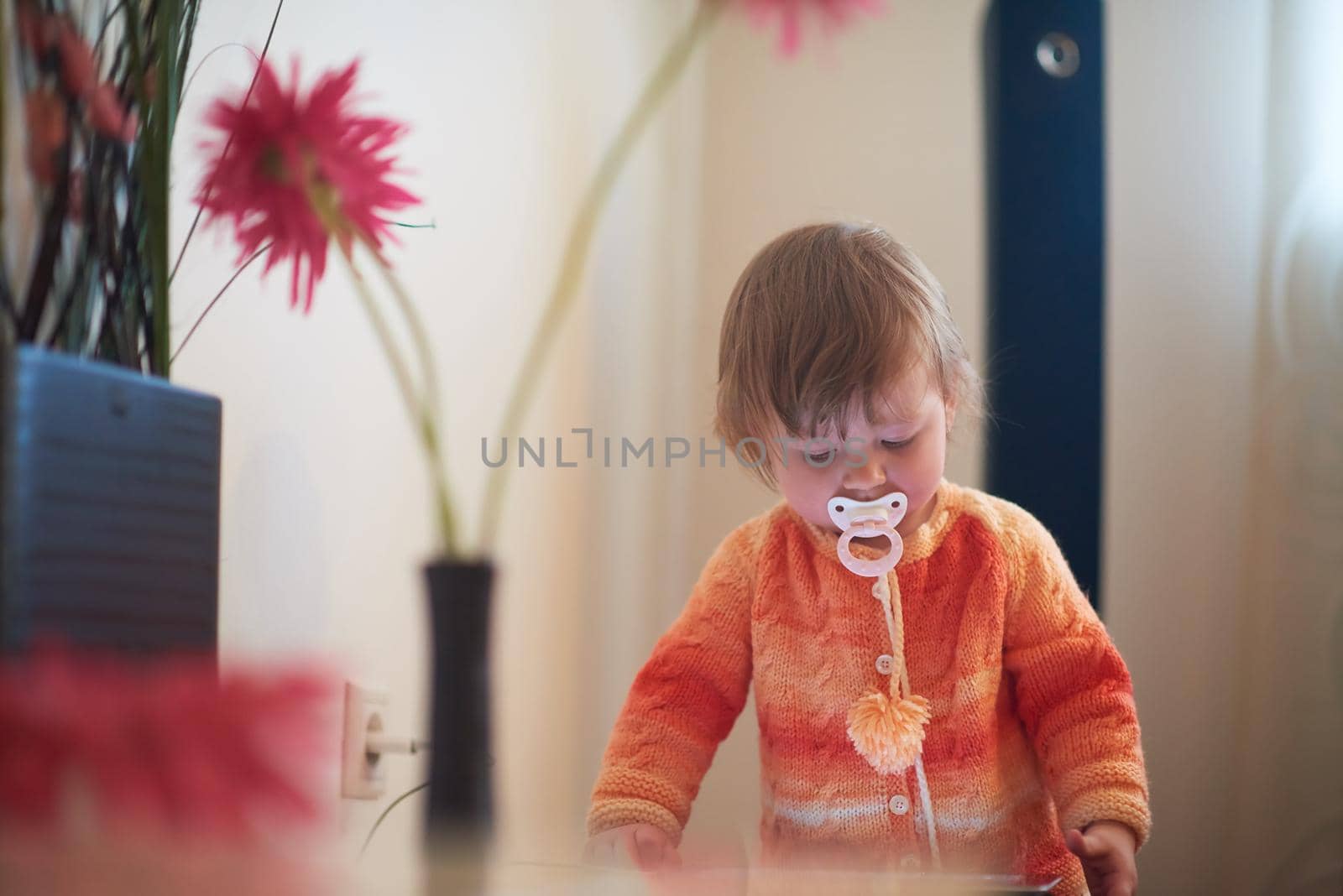 baby playing with tablet at home by dotshock