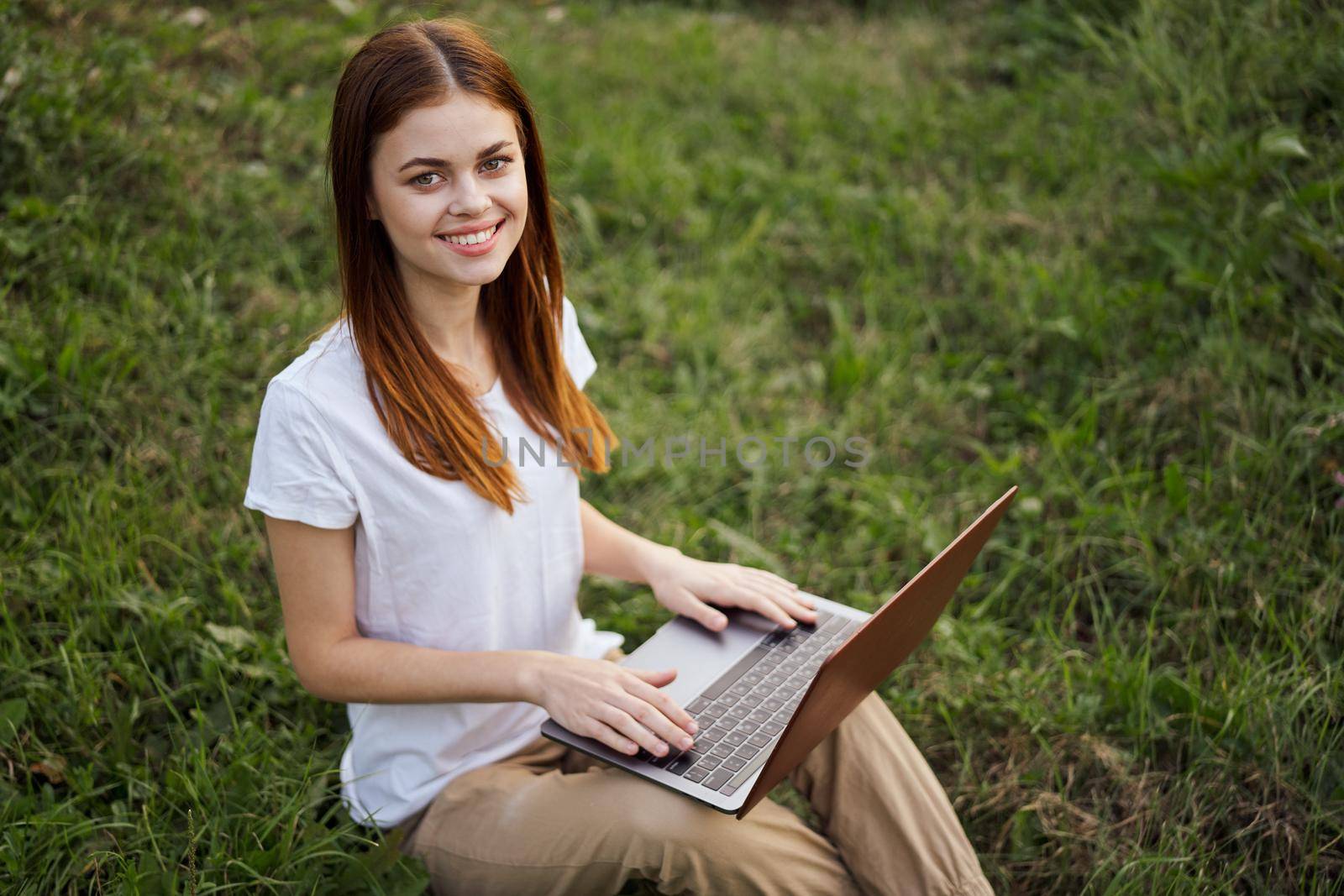 cheerful woman outdoors laptops communication internet. High quality photo