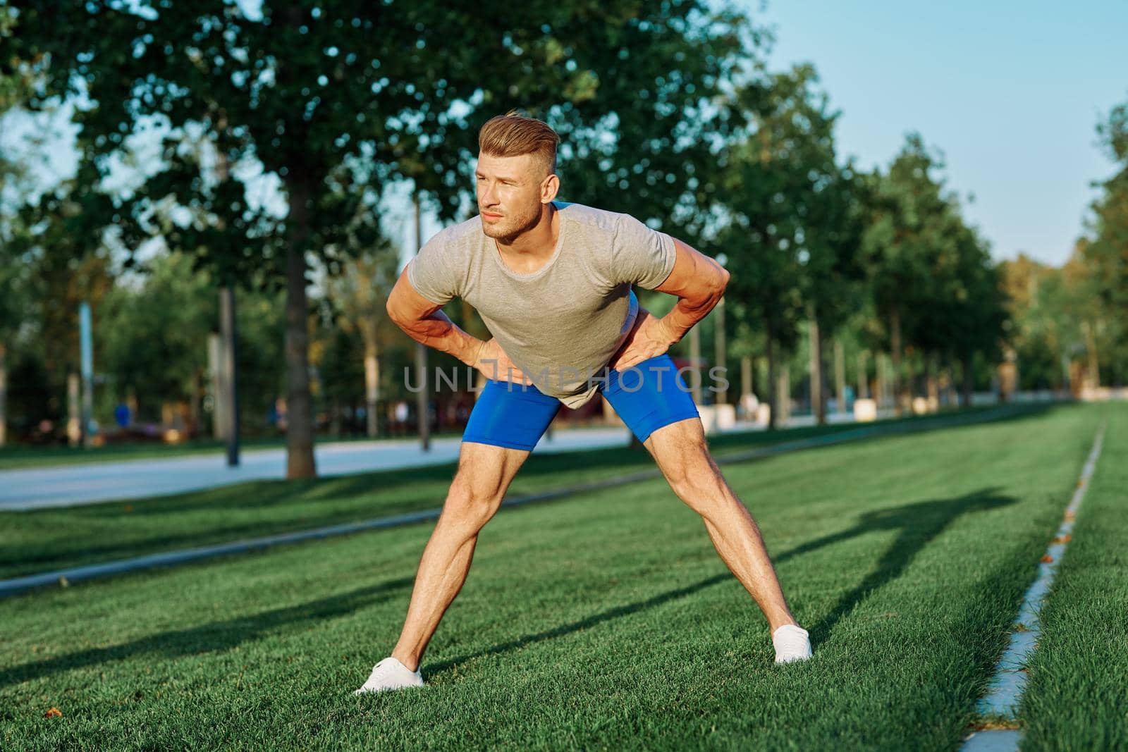 sporty man in the park on the lawn exercise lifestyle. High quality photo