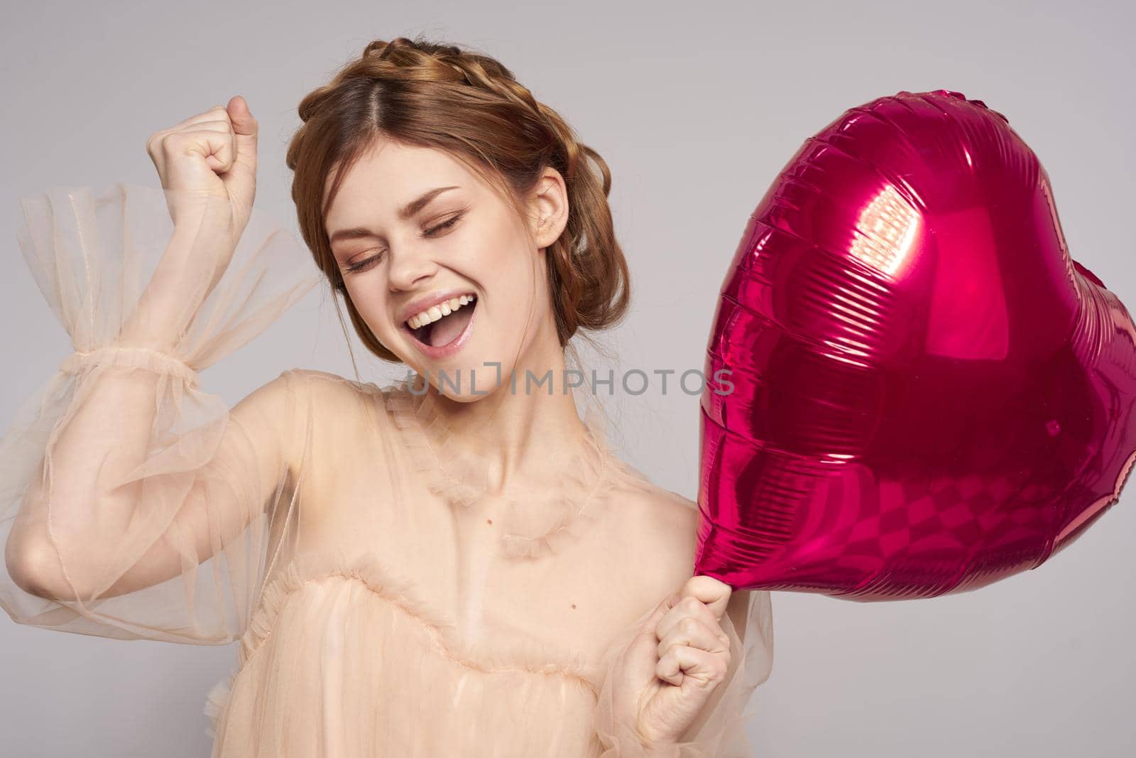 portrait of a woman Birthday party gift heart balloon model studio. High quality photo