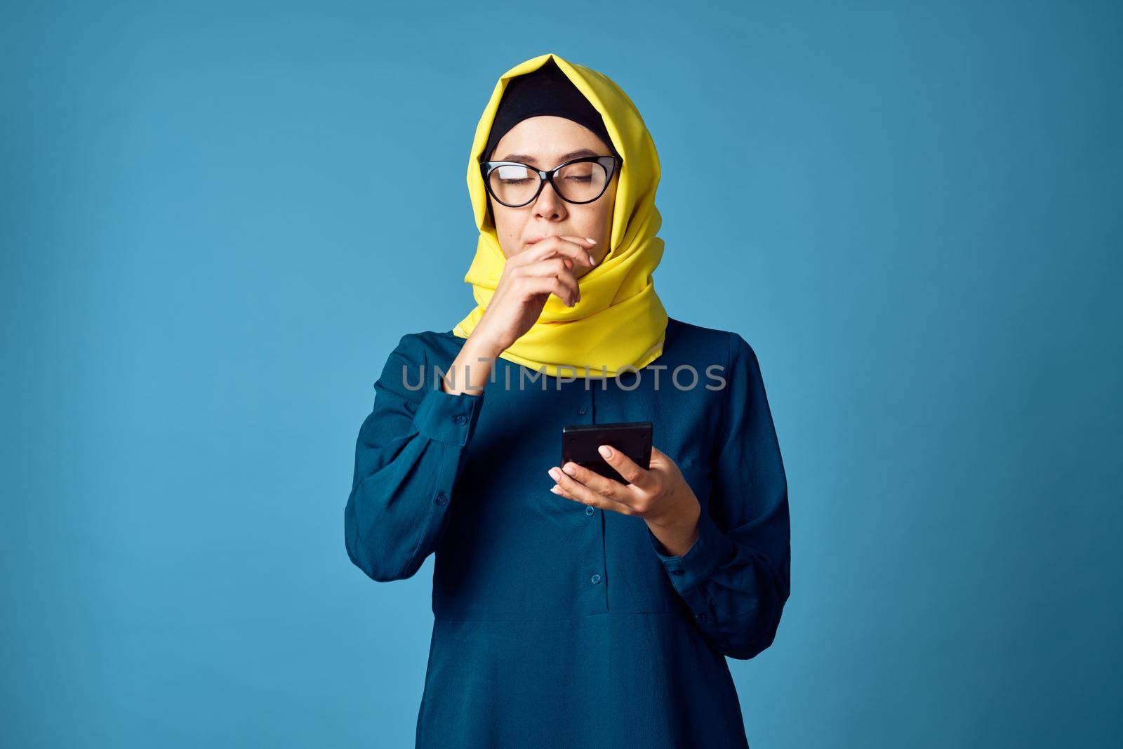 woman in yellow hijab technology calculator work finance. High quality photo