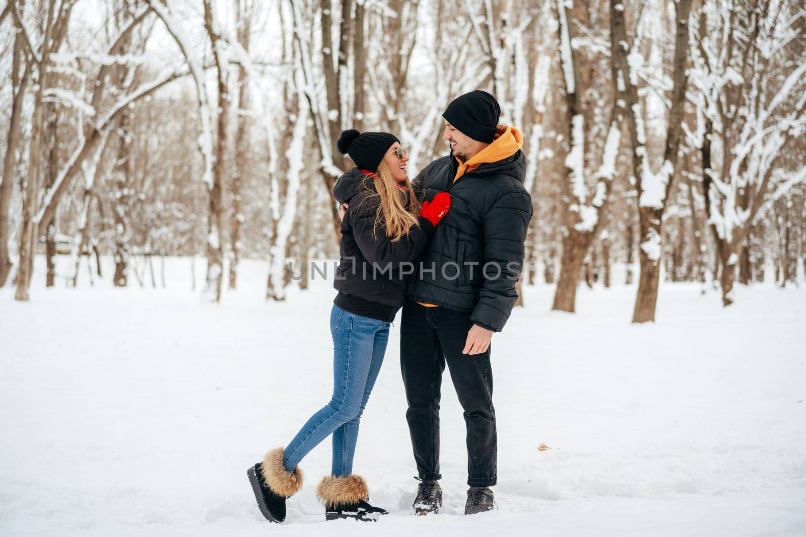 Young happy couple in love having a walk in a winter park by Fabrikasimf