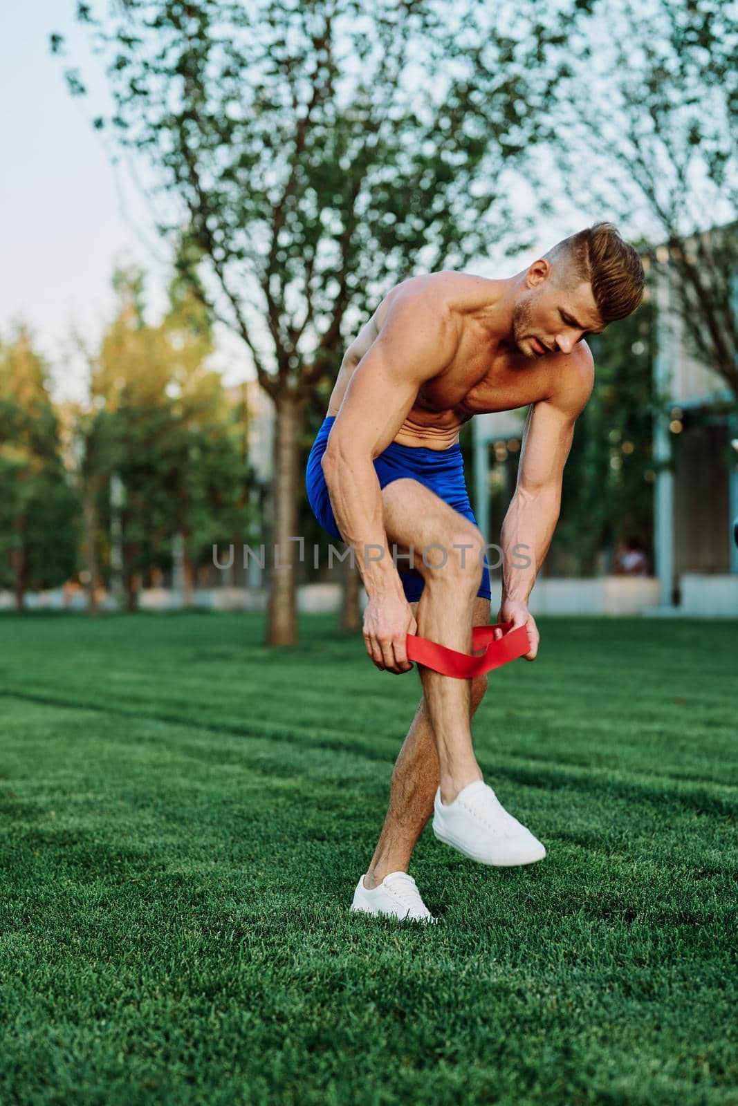 male athlete with pumped up body in parks crossfit workout by Vichizh