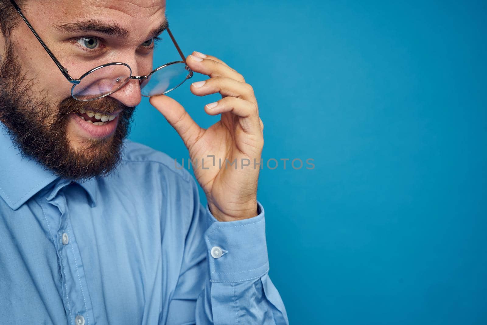 business man with glasses emotions blue background. High quality photo