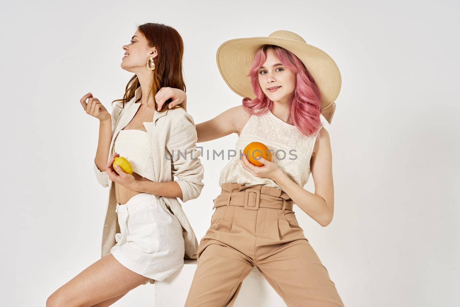 two women in fashionable clothes posing model decoration. High quality photo