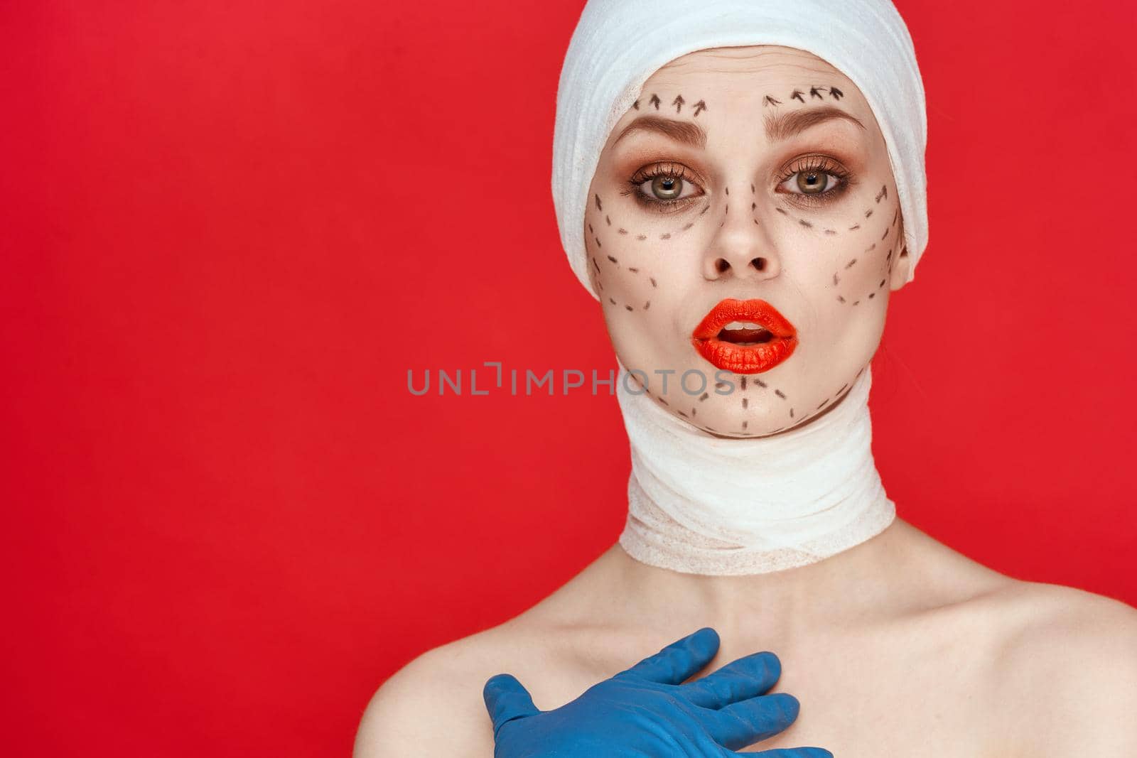 woman posing in blue gloves red lips surgery facial rejuvenation isolated background. High quality photo