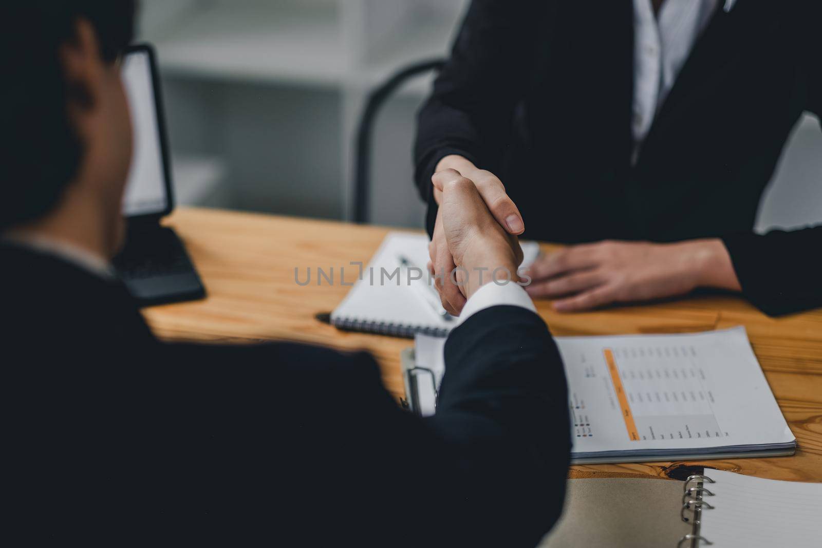 Close up business people shaking hands, finishing up meeting. success, dealing, greeting and partner concept. by nateemee