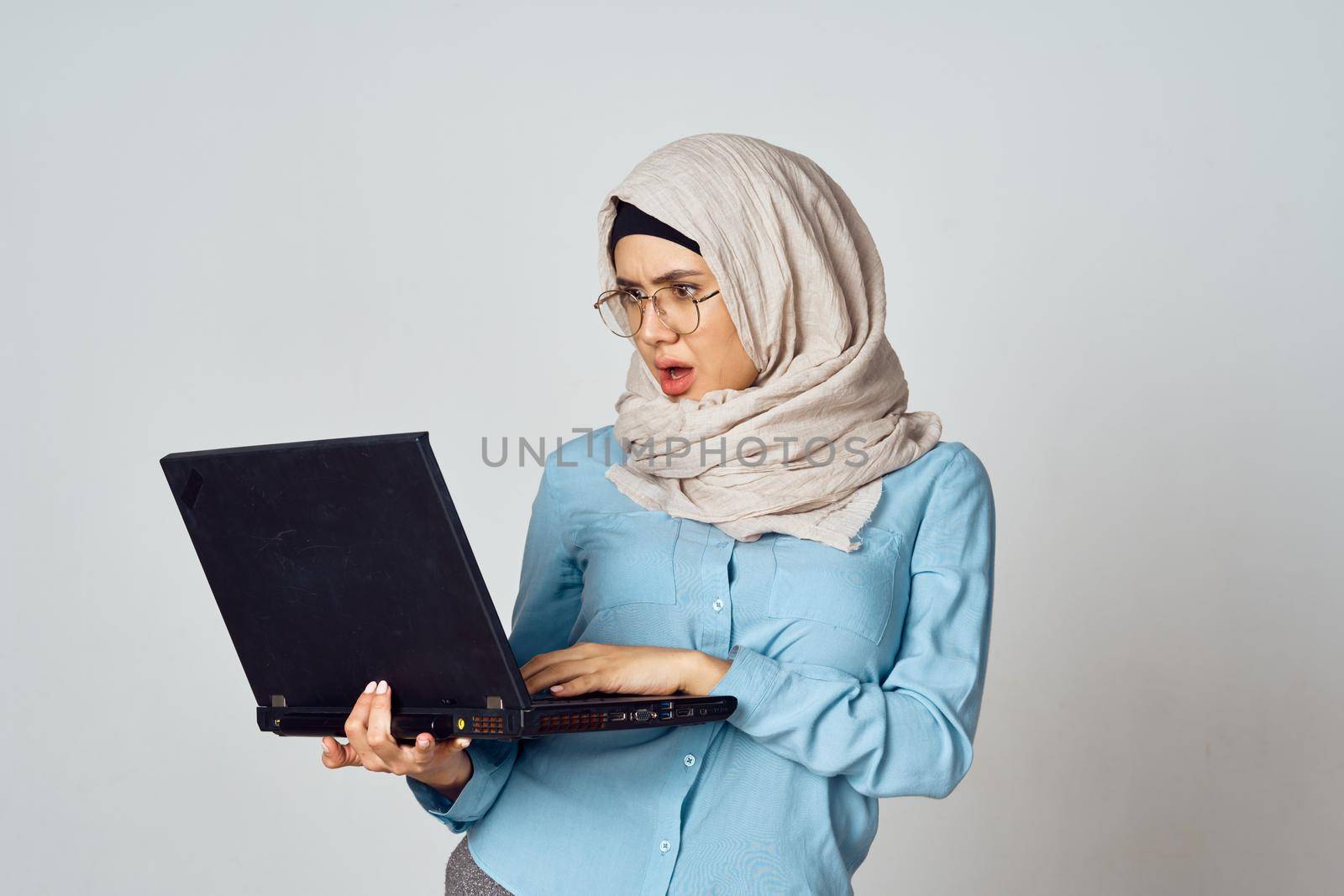 muslim woman in hijab with laptop coffee cup work. High quality photo