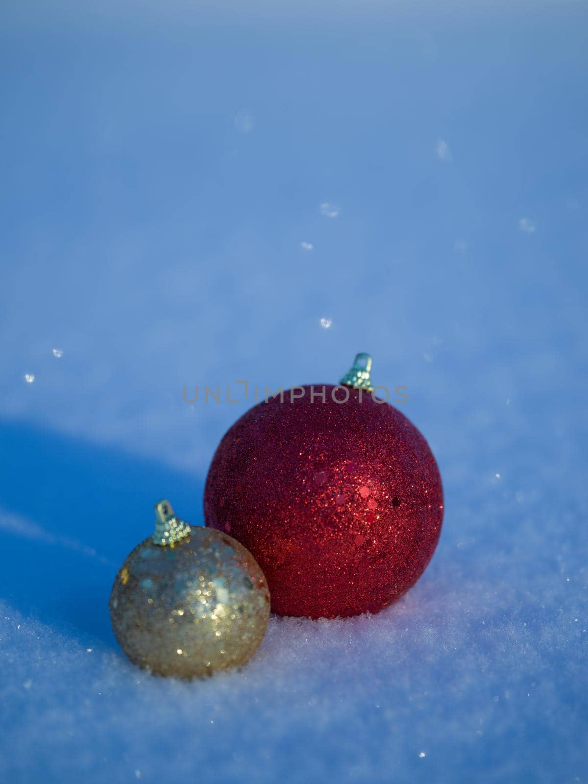 christmas balls tree decoration in fresh snow abstract background