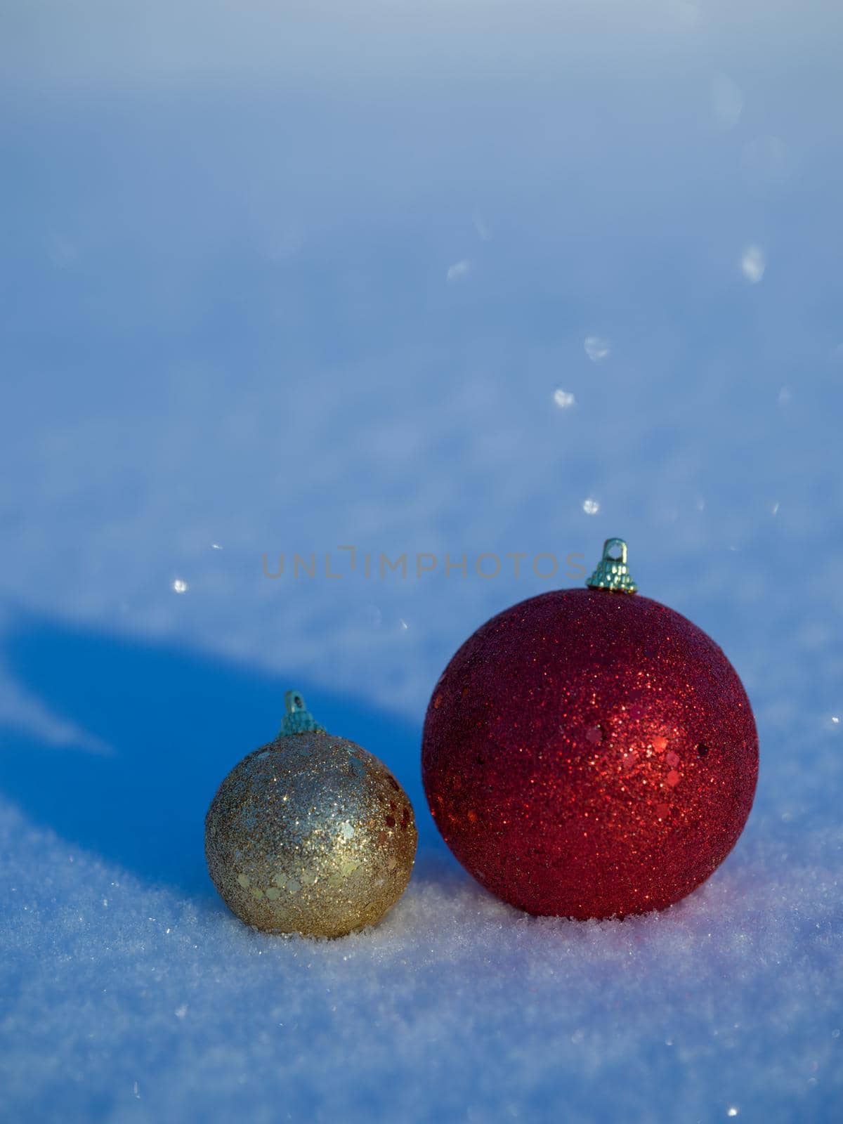 christmas balls tree decoration in fresh snow abstract background