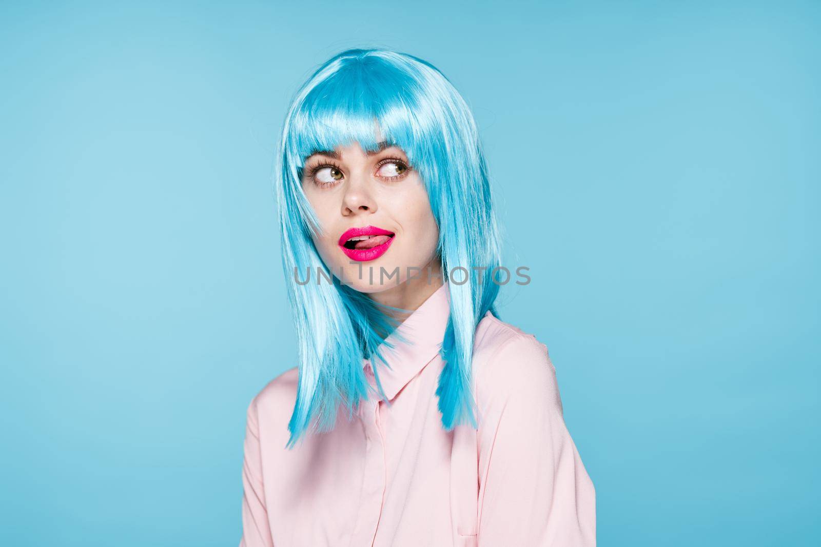 cheerful glamorous woman in pink shirt blue wig makeup model. High quality photo