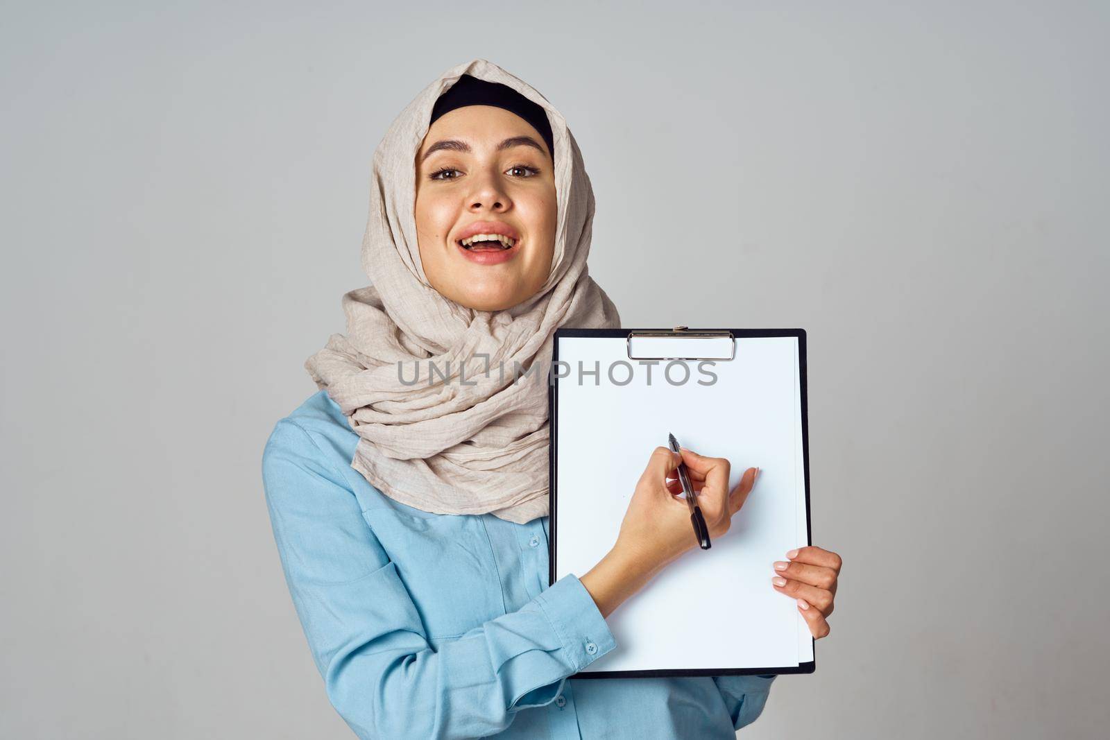 Muslim woman in hijab documents office work. High quality photo