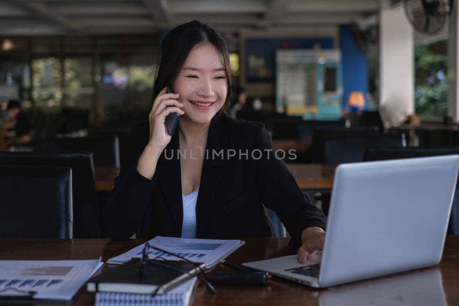 When she receives positive news from a customer, the happy businesswoman converses with her partners by cell phone