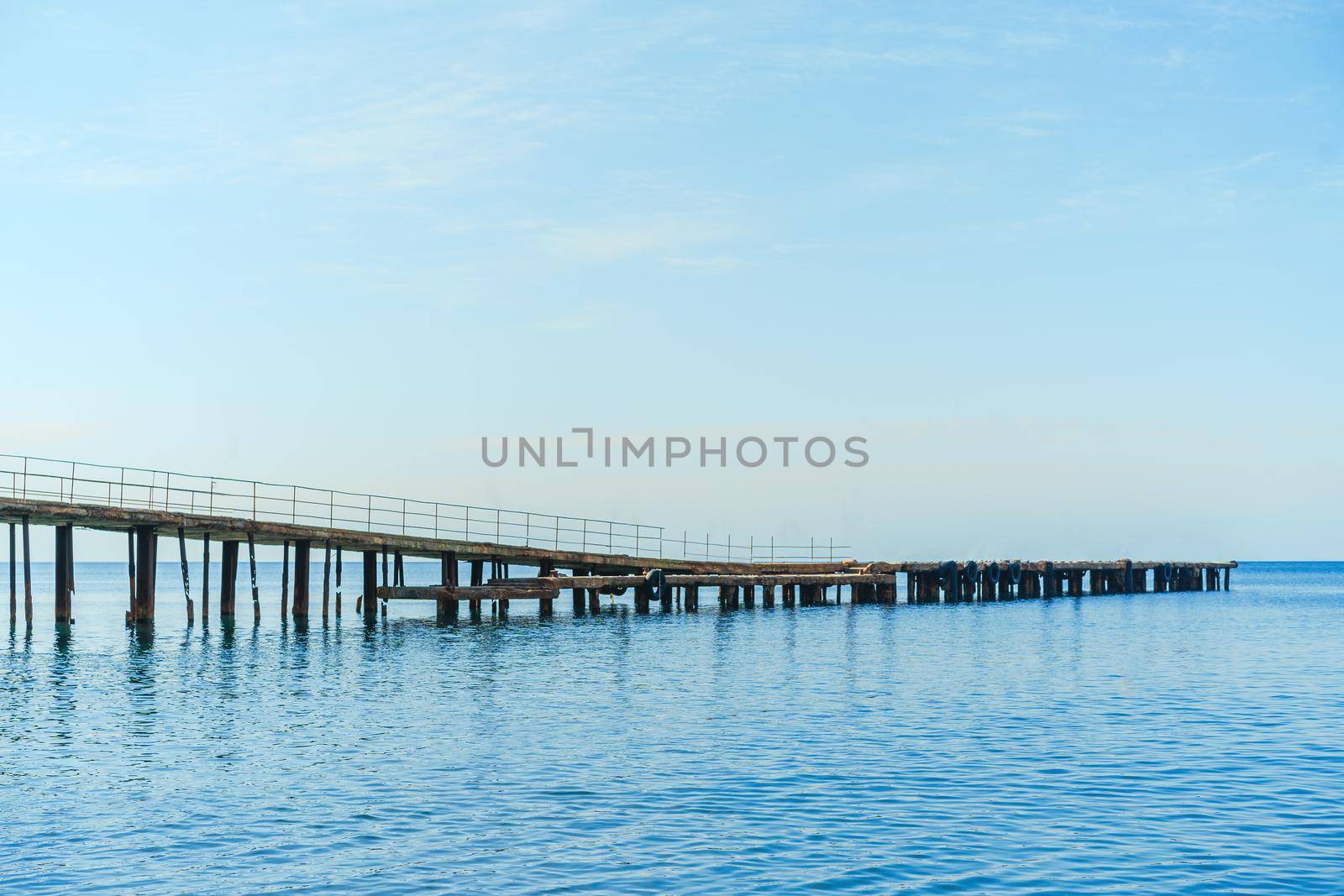 Long pier on the sea with no people by Fabrikasimf
