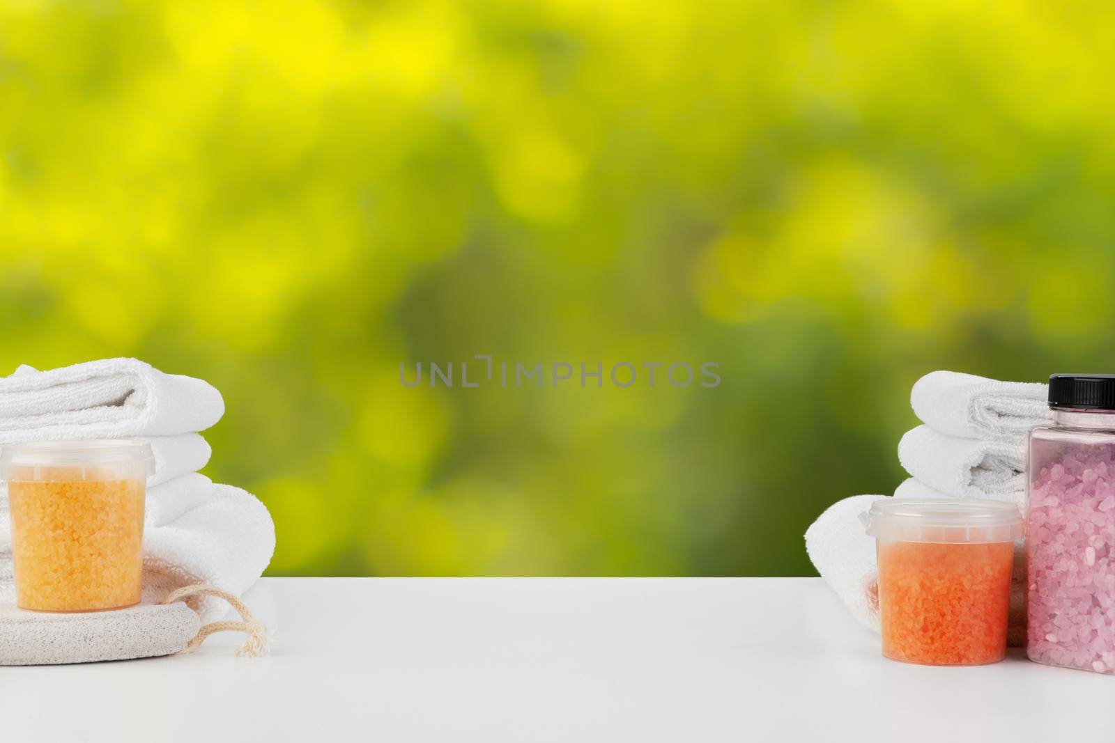 Various spa beauty threatment products and towels against blurred background by Fabrikasimf