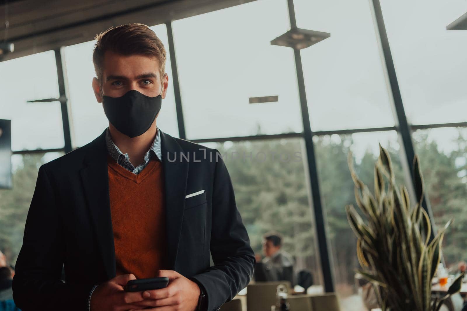 business man wearing protective face mask at office by dotshock