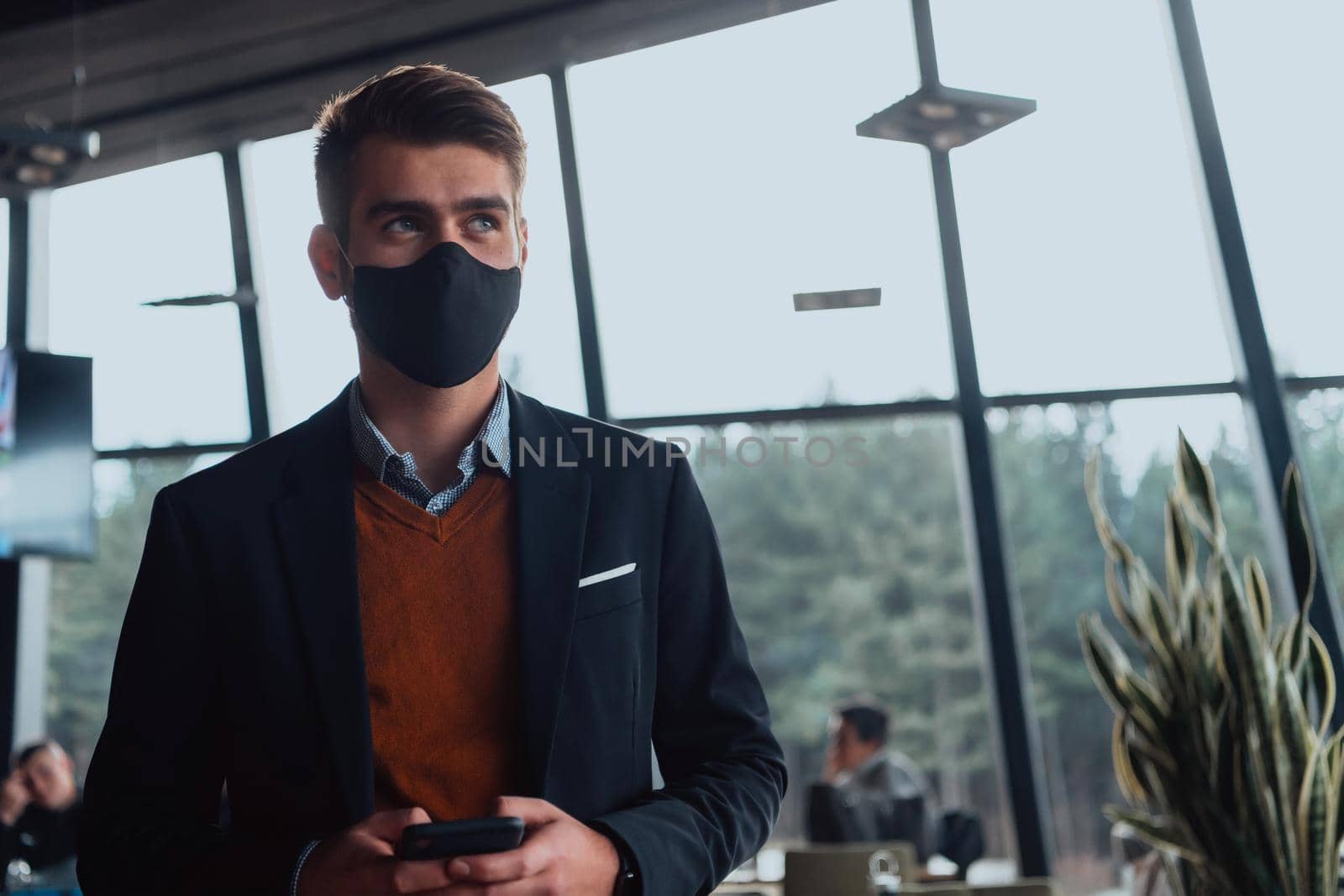 business man wearing protective face mask at office by dotshock
