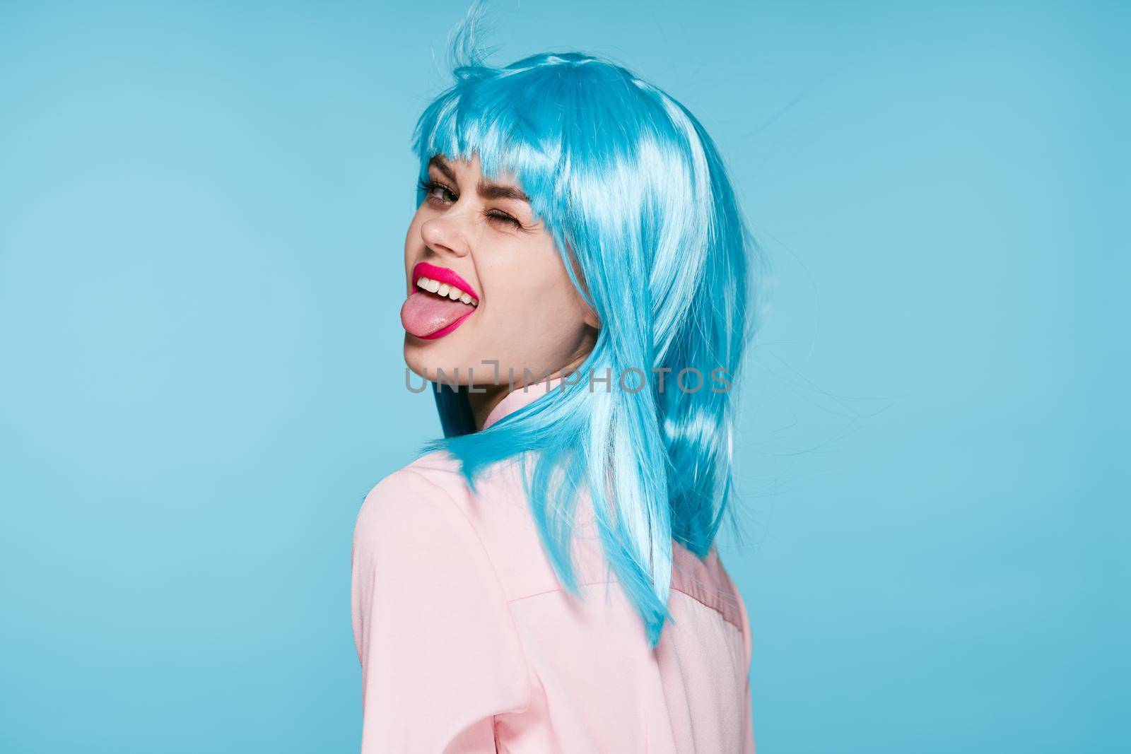 cheerful glamorous woman in pink shirt blue wig makeup model. High quality photo