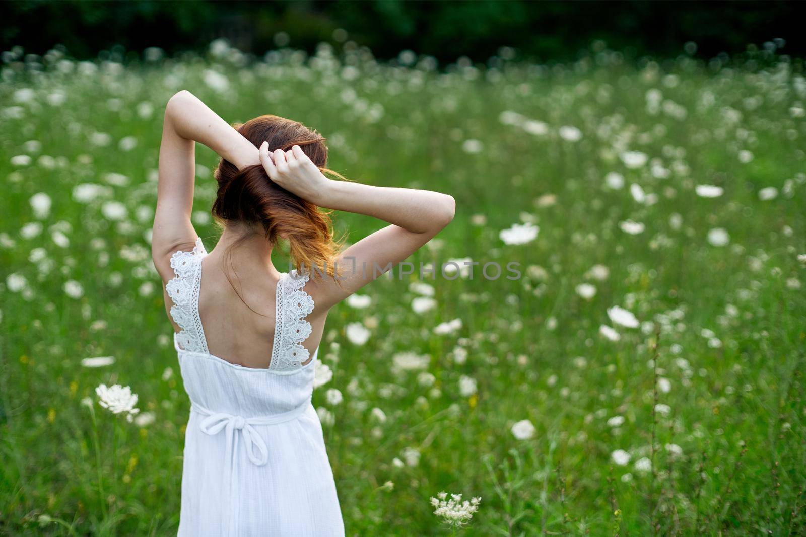 Woman in white dress in a field of flowers walk freedom by Vichizh