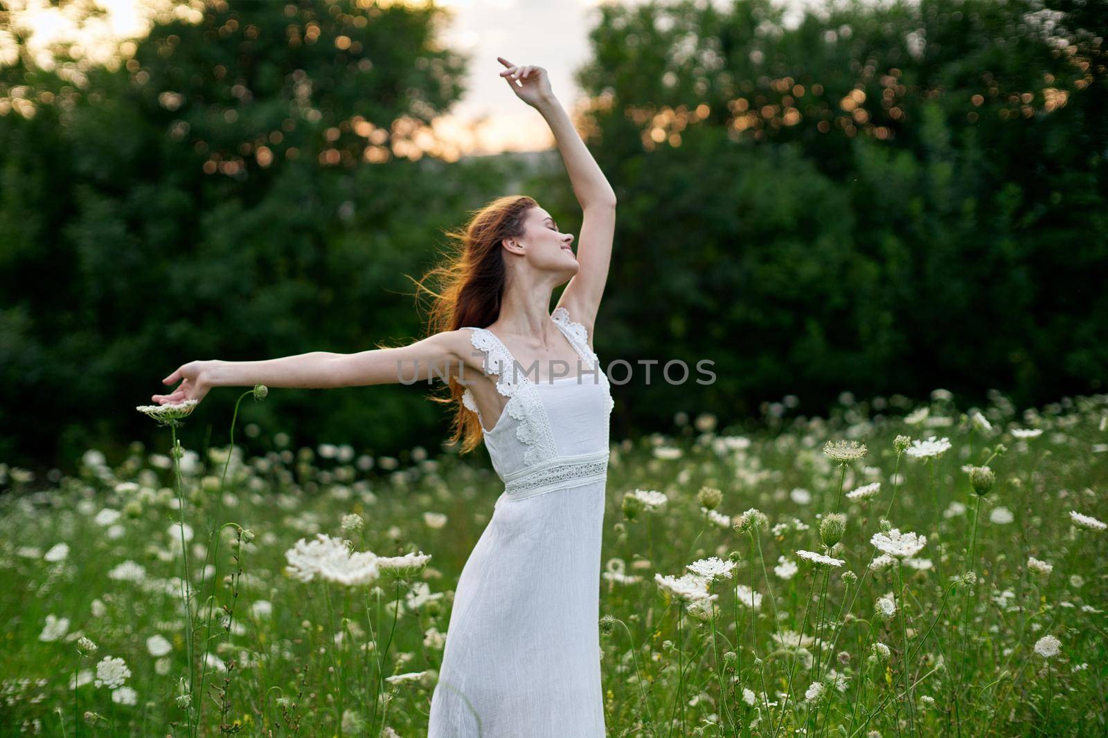 Woman in white dress in a field flowers sun nature freedom by Vichizh