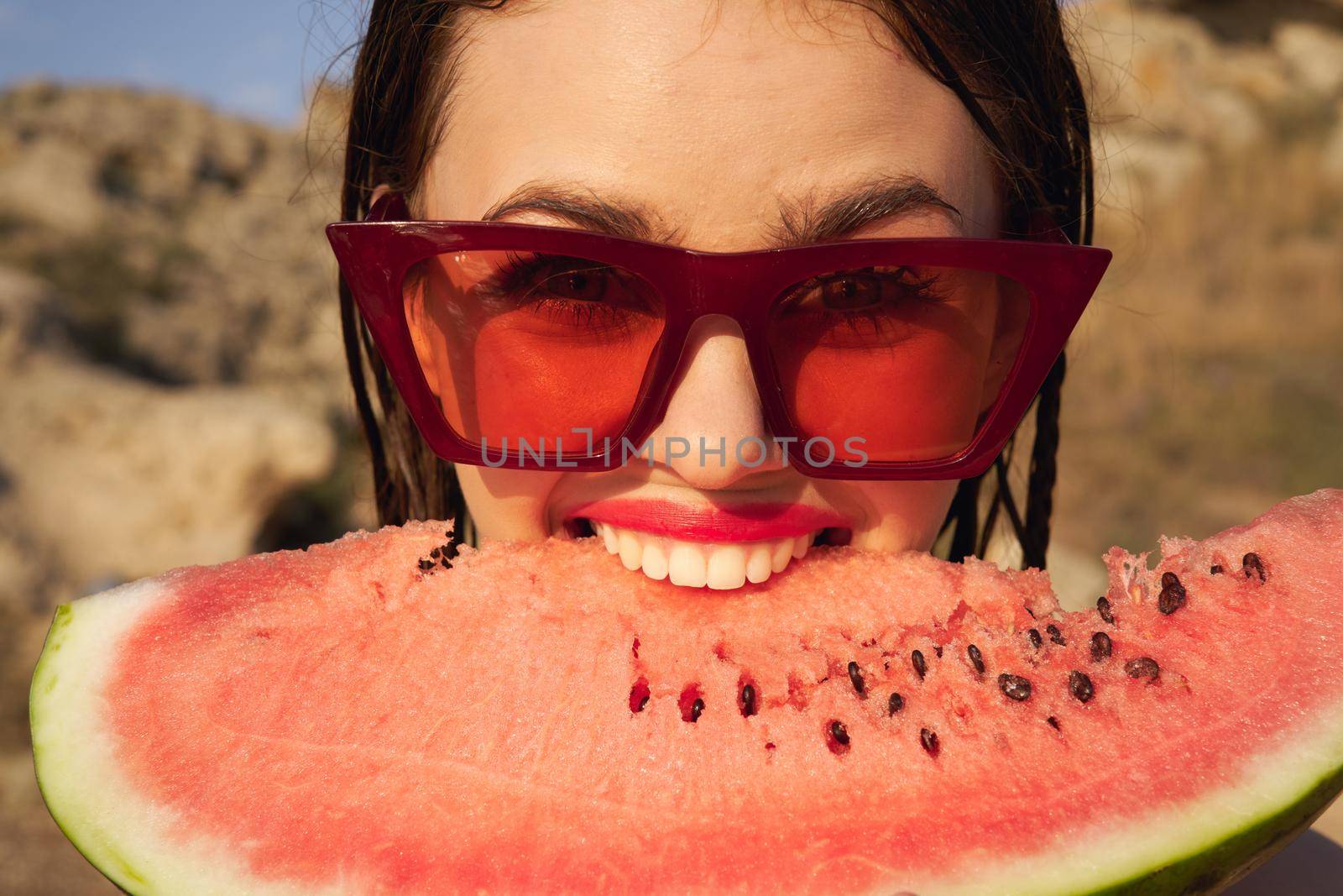 Cheerful woman eating watermelon nature summer vacation. High quality photo