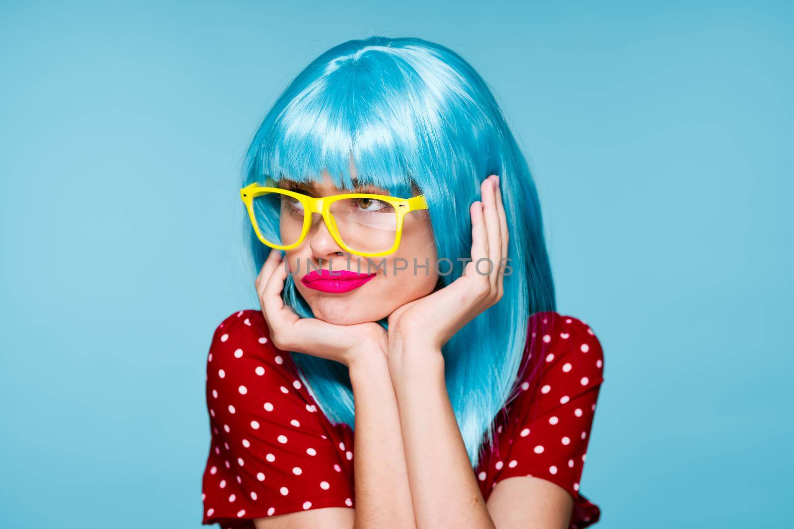 glamorous woman in blue wig yellow glasses posing model. High quality photo
