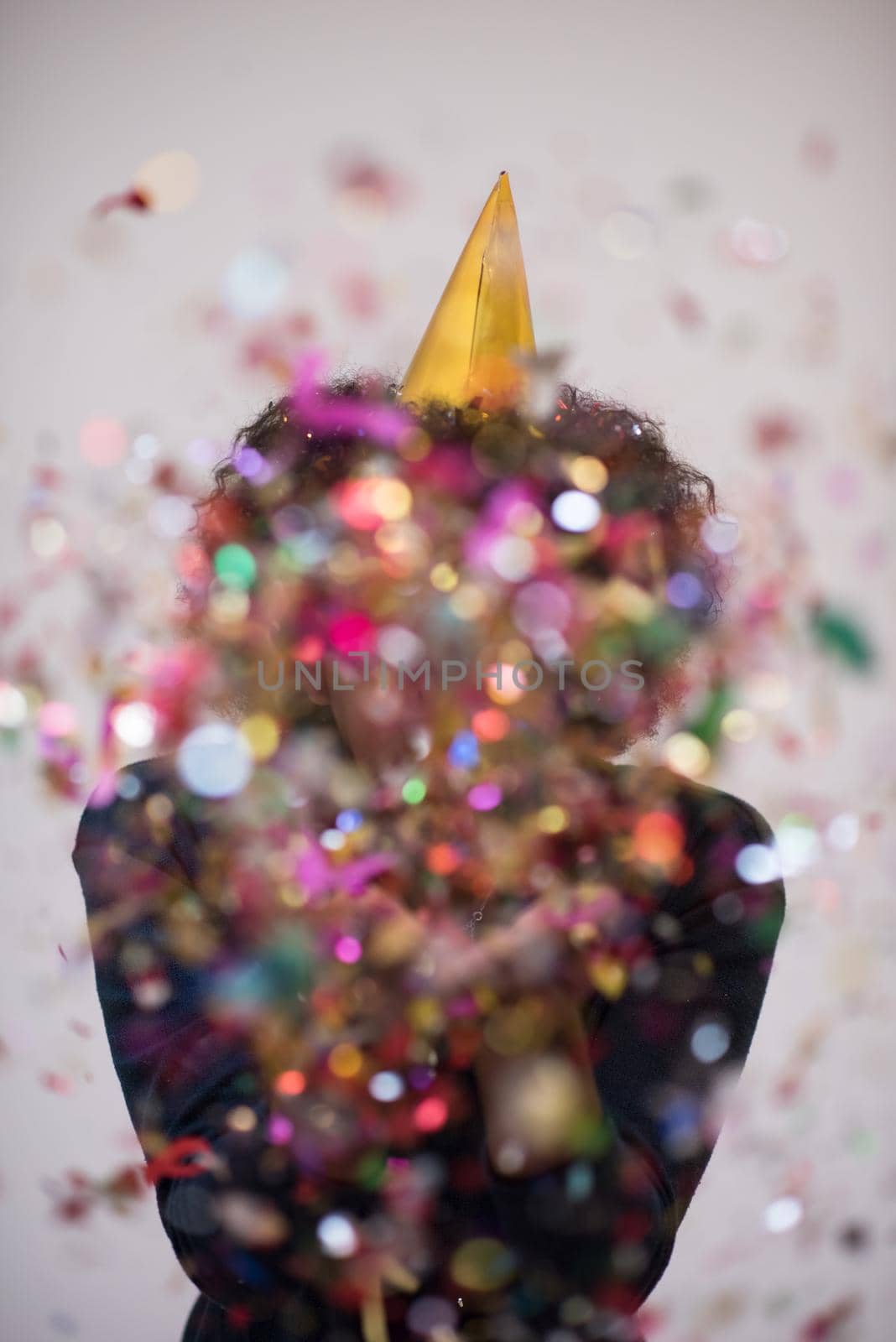 young man on party celebrating new year with falling confetti
