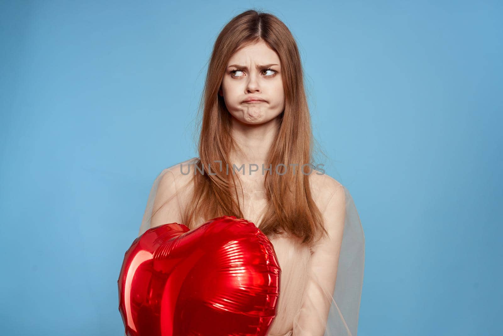 portrait of a woman Birthday party gift heart balloon blue background. High quality photo