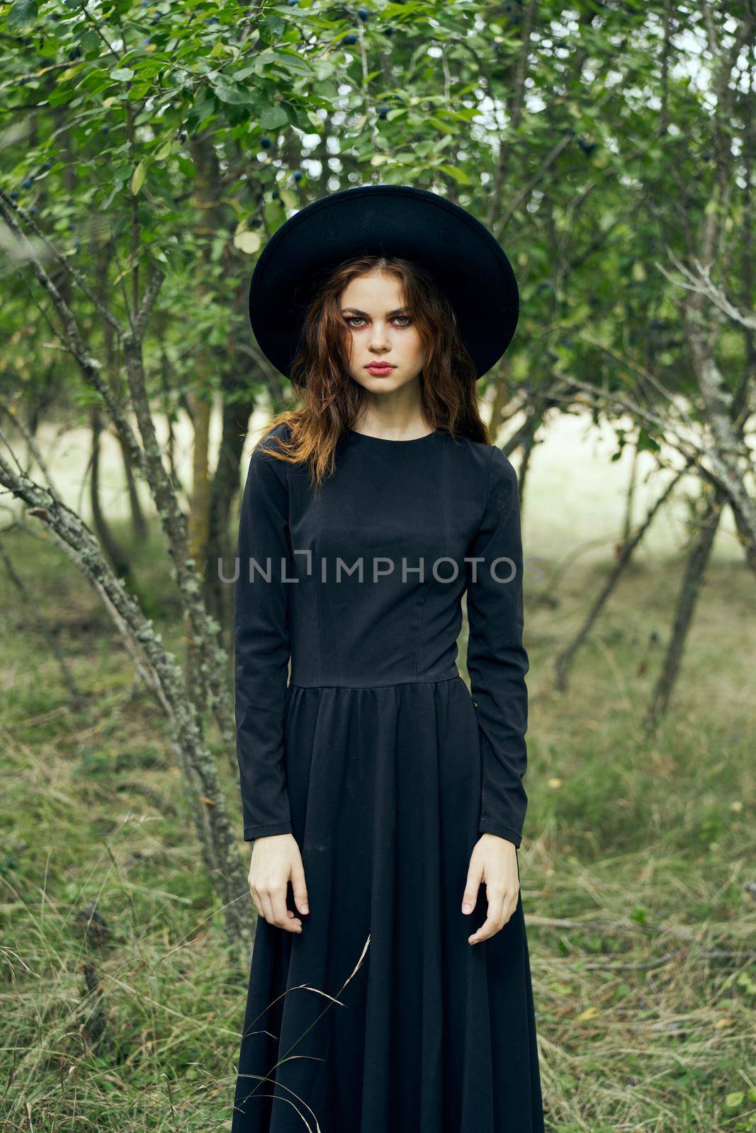 witch in the woods posing costume halloween gothic style. High quality photo