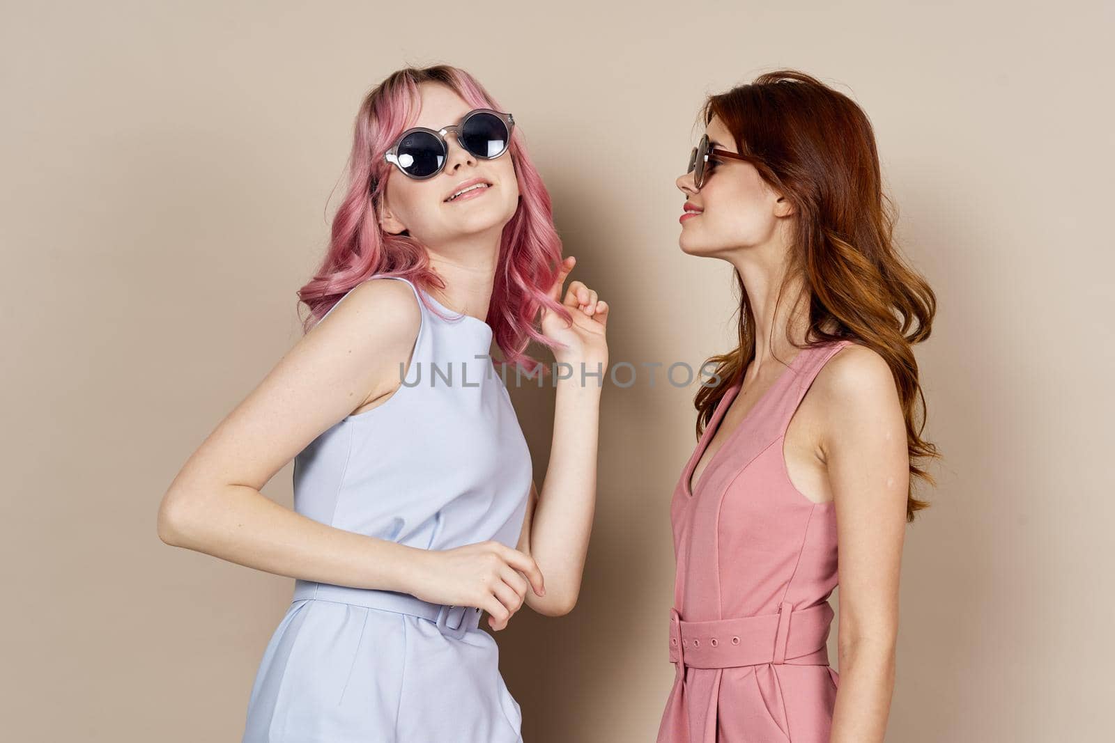 two women in fashionable clothes posing model decoration. High quality photo