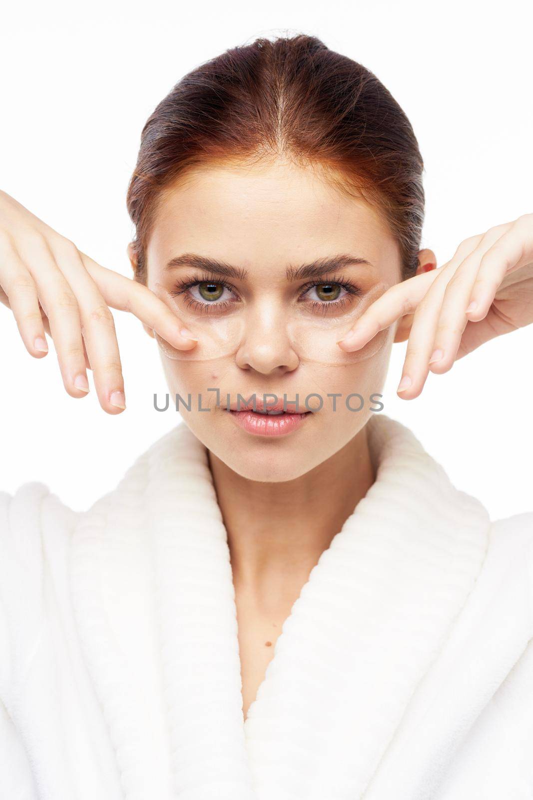 Woman in white robe posing fun skin care patches on face by Vichizh