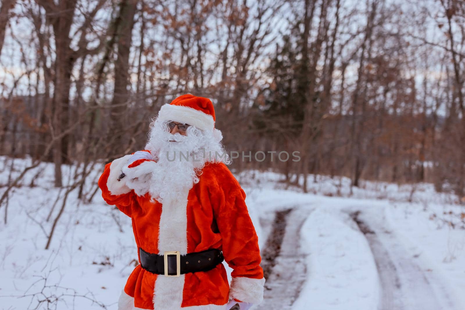 Santa Claus in the winter forest the carrying Merry Christmas present gifts for the new year to children