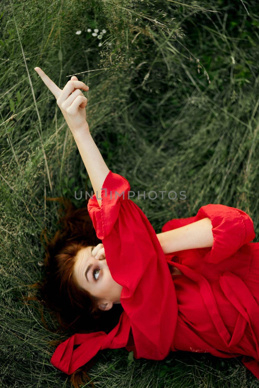 woman in red dress lies on the grass fresh air nature freedom by Vichizh