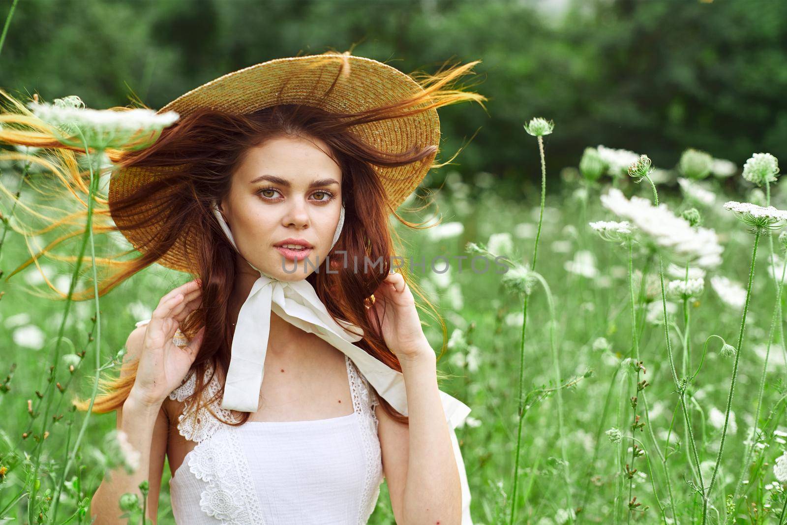 pretty woman with hat nature field flowers fresh air. High quality photo