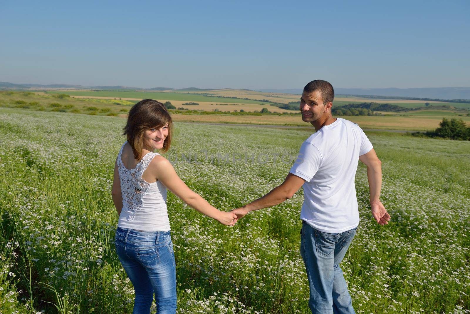 happy couple in wheat field by dotshock