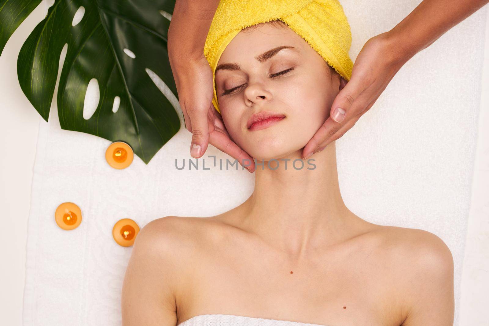 attractive woman with a towel on my head skin care light background by Vichizh