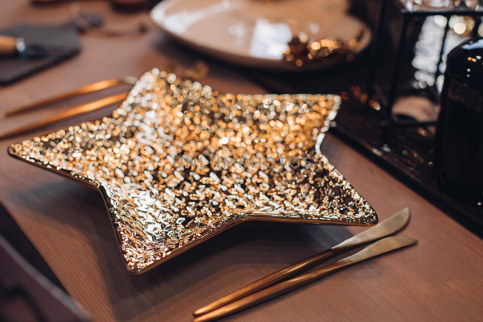 Golden star-shaped plate on New Year table. New Year eve concept