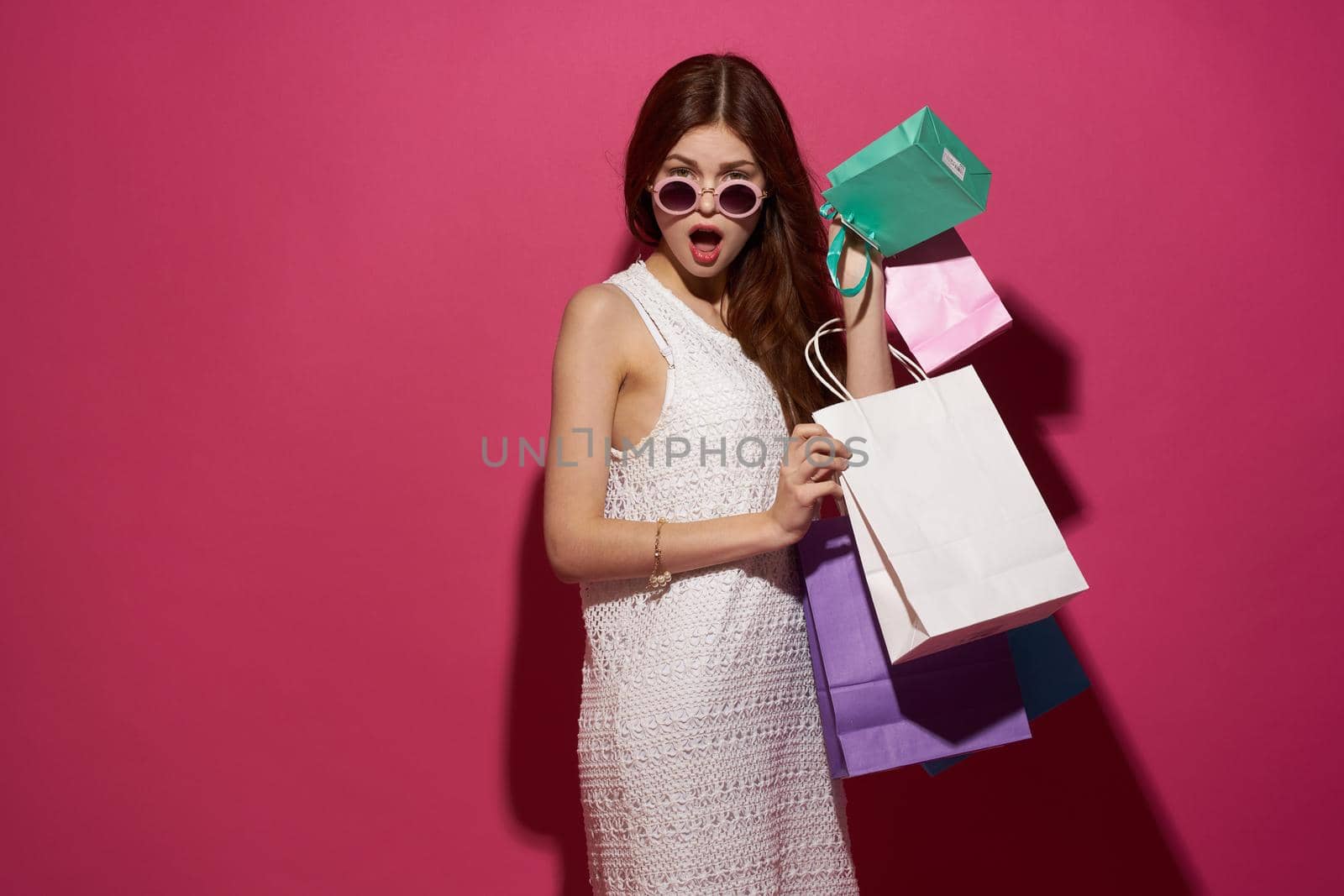 fashionable woman shopping entertainment lifestyle pink background by Vichizh