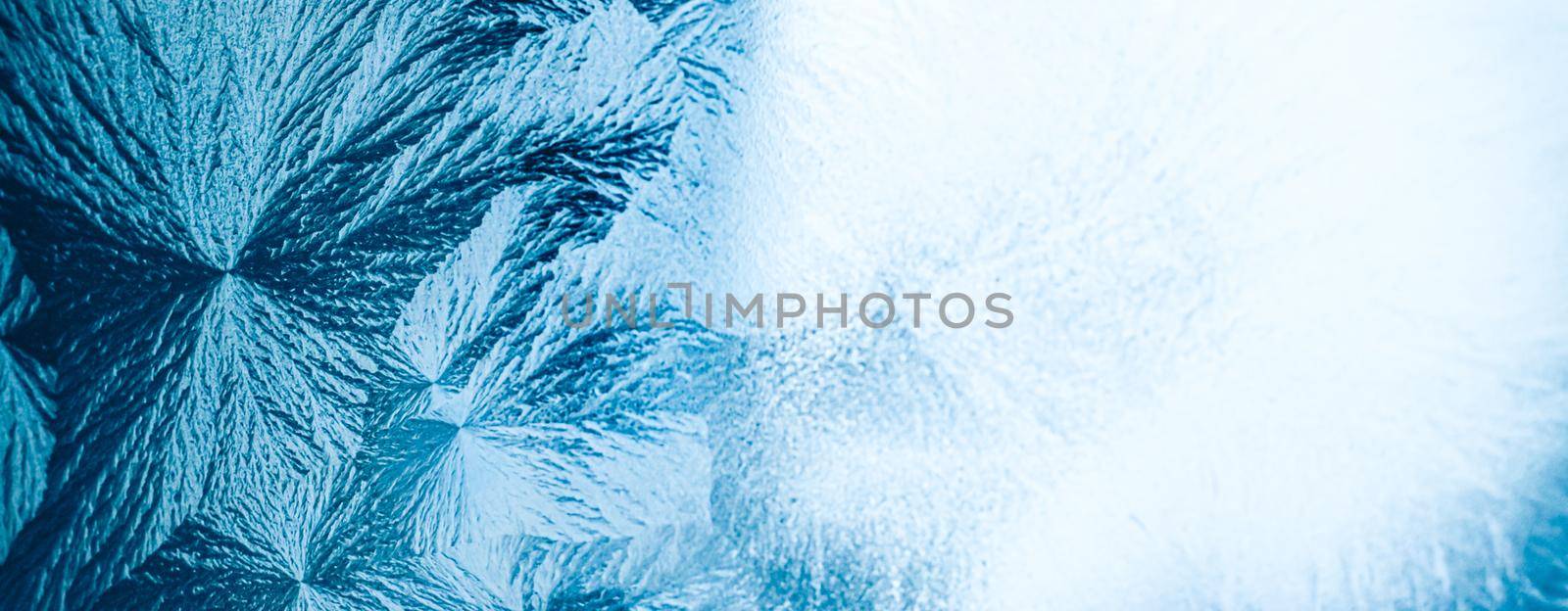 Winter background and Christmas art concept. Ice frost on frozen window glass with natural frosty pattern and texture design as holiday card backdrop.