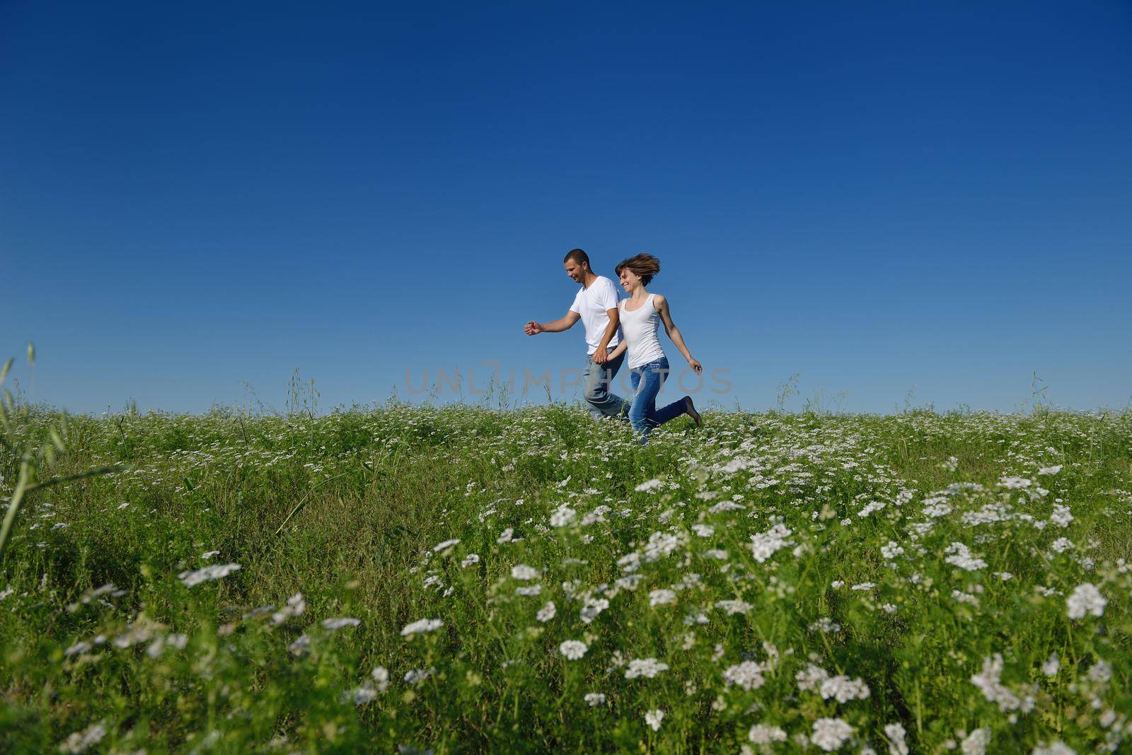 happy young couple in love have romance and fun at wheat field in summer