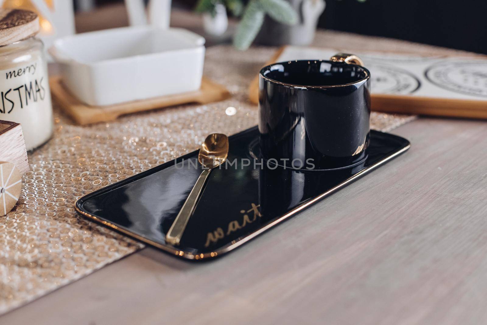 Top view of black coffee mug near wooden cutting board for cheese. Copy space