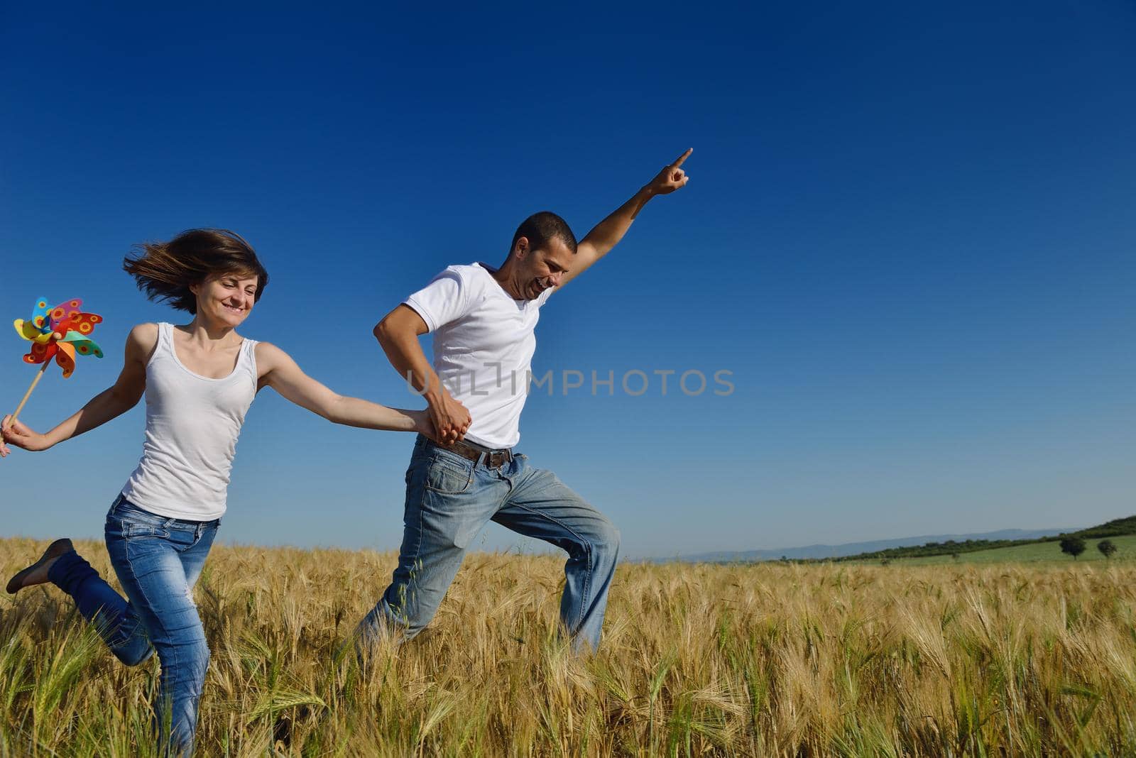 happy young couple in love have romance and fun at wheat field in summer