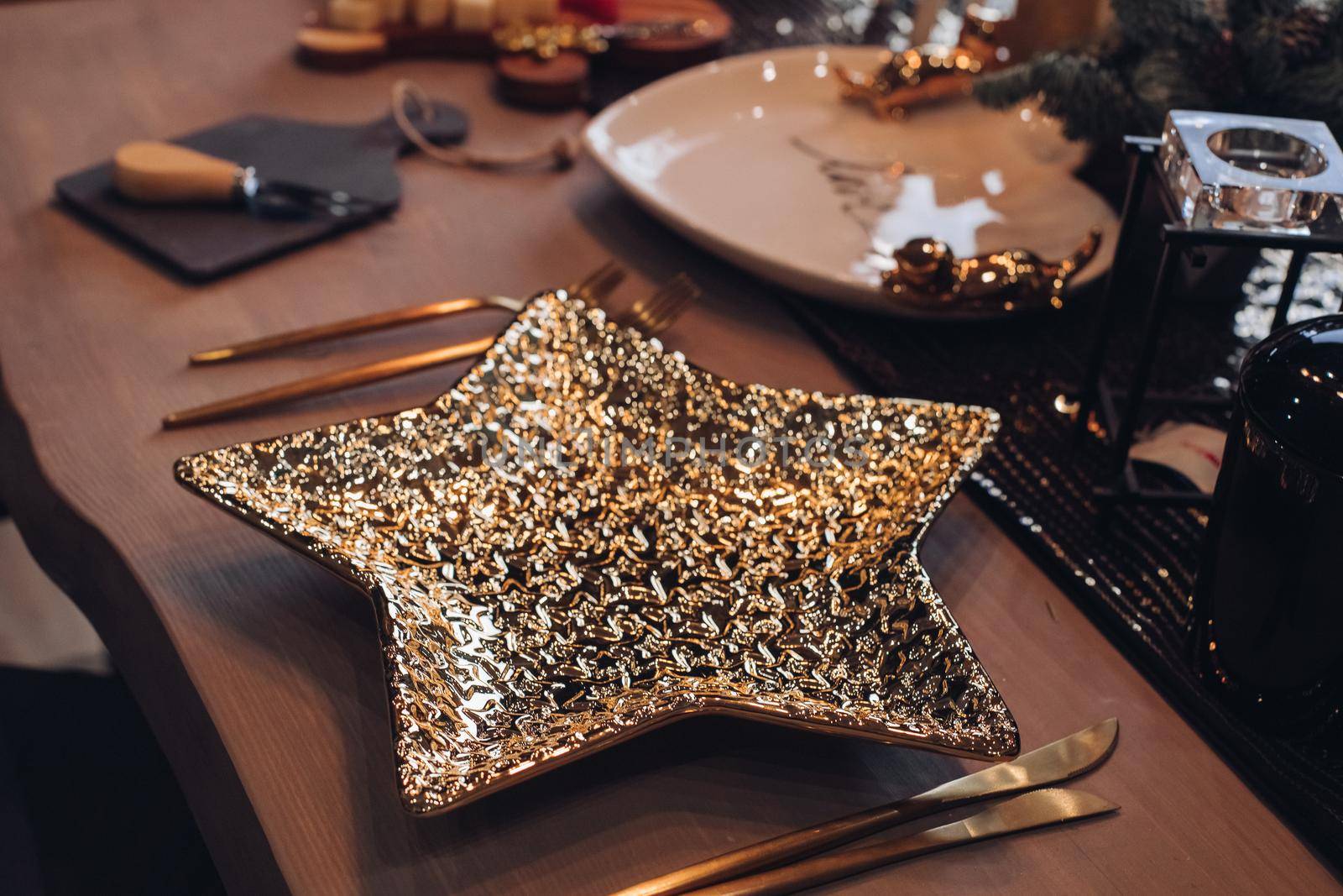 Golden star-shaped plate on New Year table. New Year eve concept