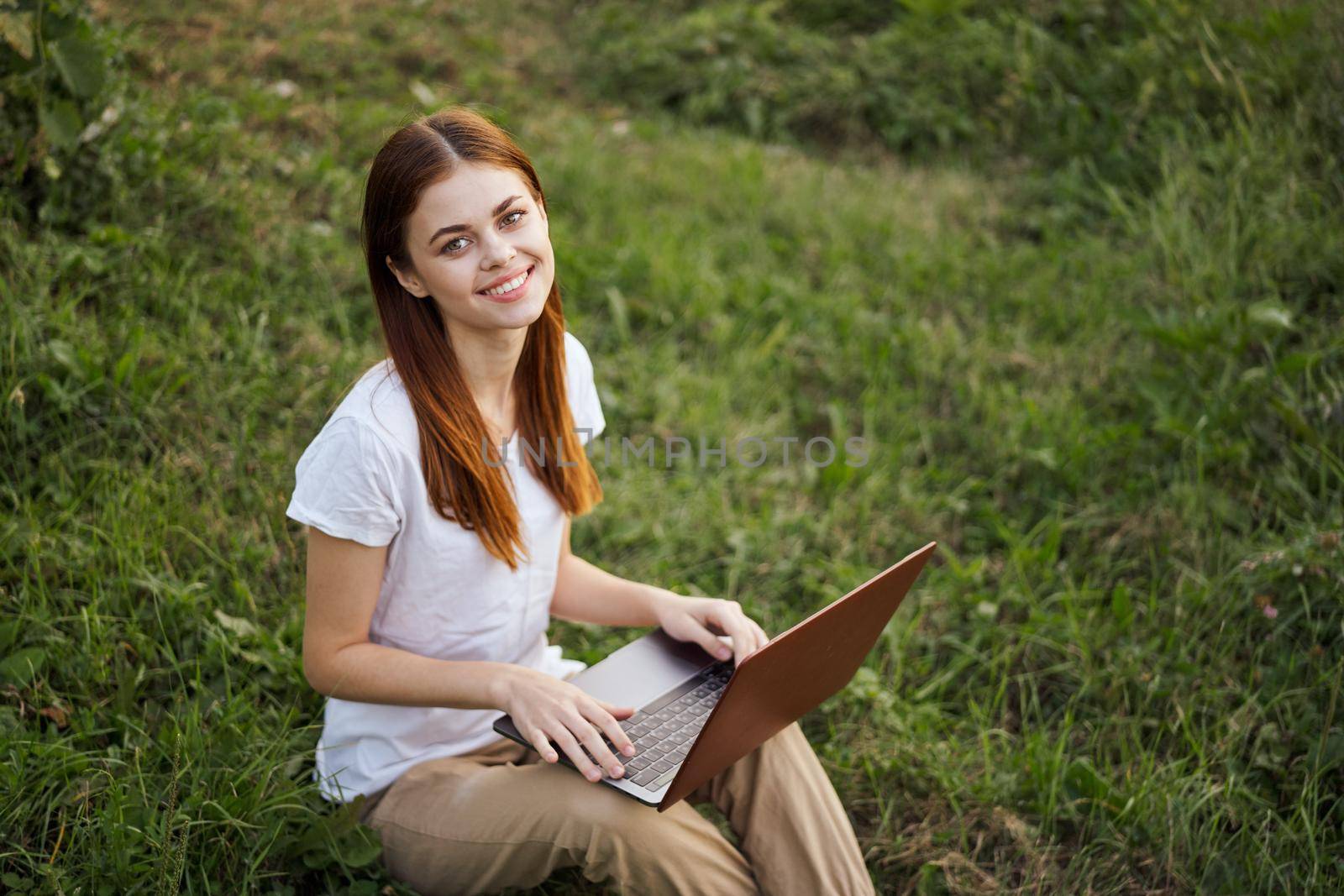 cheerful woman outdoors laptops communication internet. High quality photo