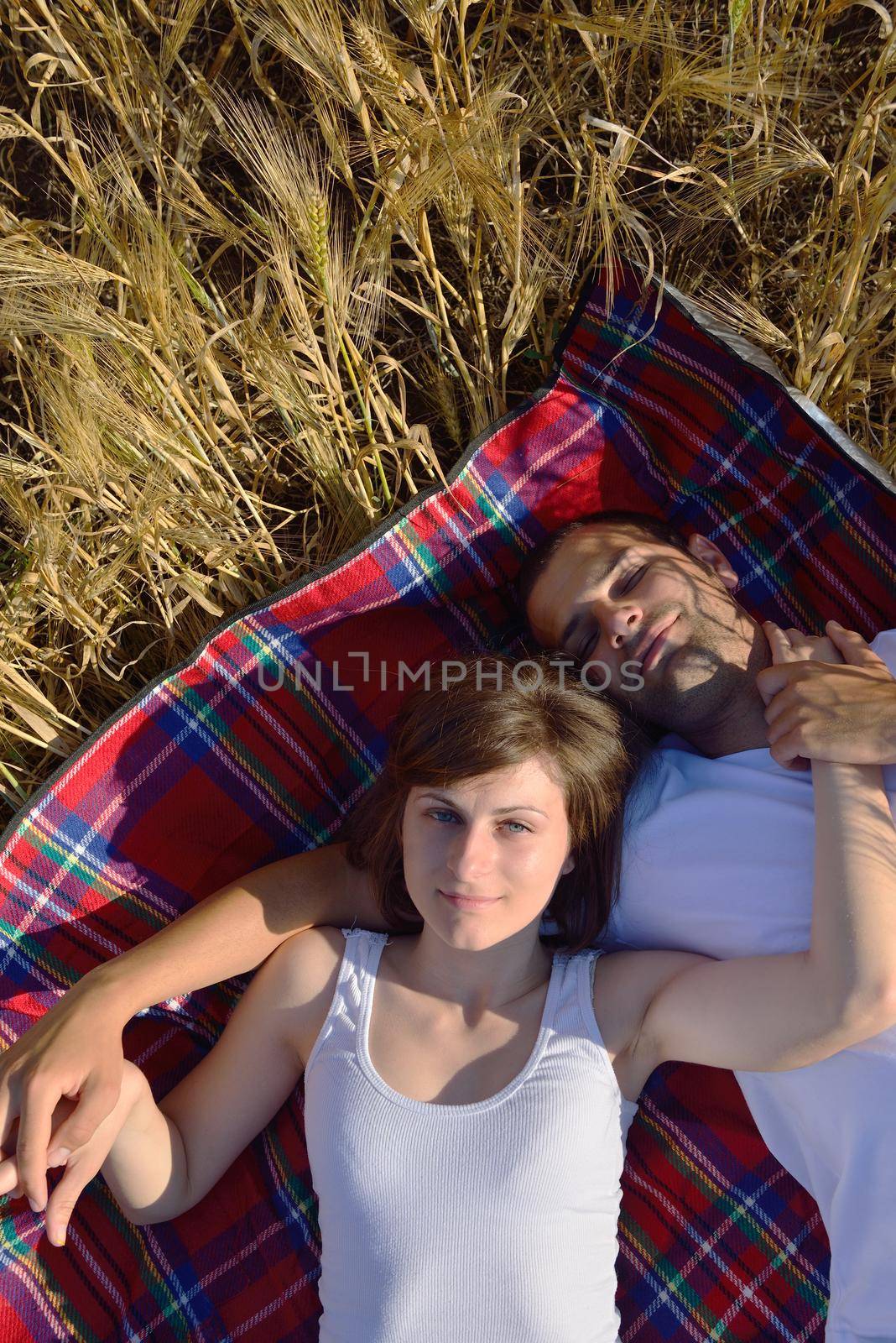 happy young couple in love have romance and fun at wheat field in summer